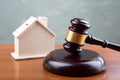 Real estate sale auction concept - gavel and house model on the wooden table Royalty Free Stock Photo