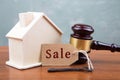 Real estate sale auction concept - gavel and house model on the wooden table Royalty Free Stock Photo