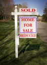 Real estate sign with sold and reduced