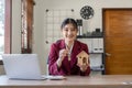 Real estate woman holding house model and house key in hand.Mortgage loan approval home loan and insurance concept. Royalty Free Stock Photo