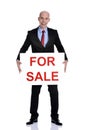 Real estate man holding a for sale sign Royalty Free Stock Photo