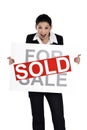 Real estate woman holding for sale - sold sign Royalty Free Stock Photo