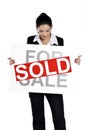 Real estate woman holding for sale - sold sign Royalty Free Stock Photo