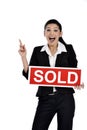 Real estate woman holding a sold sign Royalty Free Stock Photo