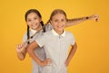 Real fun. happy friends on yellow background. fashion beauty. childhood happiness. sisterhood concept. small girls in
