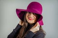 Real girl with garnet hat over gray background Royalty Free Stock Photo