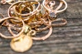 Real gold rings with diamond on weathered pine wood board close up macro shot, focus on the neckless Royalty Free Stock Photo