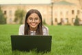 Real happiness. happy girl sitting on green grass with laptop. Start up. child playing computer game. back to school Royalty Free Stock Photo