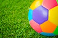 Real leather Colorful multi colour Soccer ball on green grass . Royalty Free Stock Photo