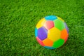 Real leather Colorful multi colour Soccer ball on green grass . Royalty Free Stock Photo