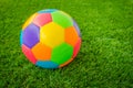 Real leather Colorful multi colour Soccer ball on green grass . Royalty Free Stock Photo
