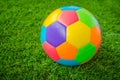 Real leather Colorful multi colour Soccer ball on green grass . Royalty Free Stock Photo