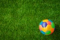 Real leather Colorful multi colour Soccer ball on green grass . Royalty Free Stock Photo