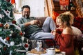 Real life leisure activity in chrismtas holiday at home for man and woman having breakfast together with italian coffee. Happiness