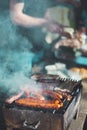 Real life man preparing barbeque on picnic