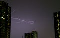 The Real Lightning Flashing on Night Sky over the High Buildings Royalty Free Stock Photo