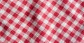Real linen picnic tablecloth. Red and white checkered high detailed fabric background.