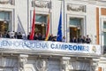 Real Madrid celebration in the Puerta del Sol building in Madrid. Square full of people watching the club players.