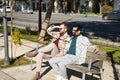 Real marriage of gay couple, holding hands, sitting on a wooden bench, talking accomplices and happy. Concept lgtb, lgtbiq+, Royalty Free Stock Photo