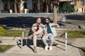 Real marriage of gay couple, holding hands, sitting on a wooden bench, talking accomplices and happy. Concept lgtb, lgtbiq+, Royalty Free Stock Photo