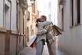 Real marriage of gay couple, hugging on the street, hands full of shopping bags, happy for their gifts. Concept lgtb, lgtbiq+,