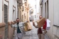 Real marriage of gay couple, walking down the street, hands full of shopping bags, happy and funny. Concept lgtb, lgtbiq+, couples Royalty Free Stock Photo