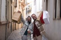 Real marriage of gay couple, walking down the street, hands full of shopping bags, happy and funny. Concept lgtb, lgtbiq+, couples Royalty Free Stock Photo