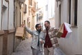 Real marriage of gay couple, walking down the street, hands full of shopping bags, happy and funny. Concept lgtb, lgtbiq+, couples Royalty Free Stock Photo