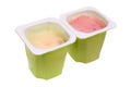 Real nonfat fruits  yogurt in green open plastic cups isolated macro Royalty Free Stock Photo