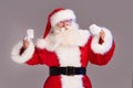 Real old Santa Claus on showing his power, posing on a grey studio background. Merry Christmas and Happy New Year! Copy space Royalty Free Stock Photo