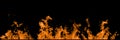 Real orange line of fire flames isolated on black background. Mockup on black of wall of fire