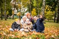 Happy mom, dad and sons playing having fun together, taking selfie on the mobile phone at the autumn park Royalty Free Stock Photo