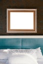 Real photo of a bedroom with bed, pillow and empty frame Royalty Free Stock Photo