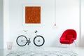 Real photo of a bike with black tires, red armchair, painting an
