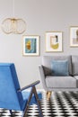 Real photo of a blue armchair standing in front of a grey couch Royalty Free Stock Photo