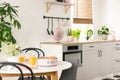 Real photo with blurred foreground of white kitchen interior wit