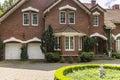 Real photo of a brick house with a bay window, garages and round Royalty Free Stock Photo