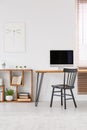 Real photo of a desk with a computer screen and a chair standing Royalty Free Stock Photo