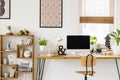 Real photo of a desk with a computer screen, lamp and ornaments Royalty Free Stock Photo