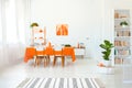 Dining room in vivid color. Orange tablecloth on table with white chairs Royalty Free Stock Photo