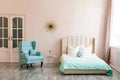 Real photo of a feminine bedroom interior with a comfy armchair, bed Royalty Free Stock Photo