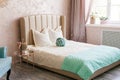 Real photo of a feminine bedroom interior with a comfy armchair, bed Royalty Free Stock Photo