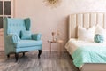 Real photo of a feminine bedroom interior with a comfy armchair, bed Royalty Free Stock Photo