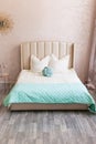 Real photo of a feminine bedroom interior with a comfy armchair, bed Royalty Free Stock Photo