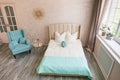 Real photo of a feminine bedroom interior with a comfy armchair, bed Royalty Free Stock Photo