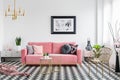 Real photo of a glamor living room interior with a powder pink s