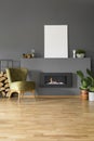 Real photo of a green armchair standing next to a bio fireplace Royalty Free Stock Photo