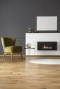 Real photo of a green armchair standing next to a bio fireplace Royalty Free Stock Photo