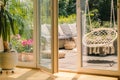 Real photo of a hanging armchair and a rattan sofa with cushions