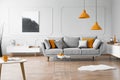 Photo of a modern living room interior with a sofa, orange lamps and painting Royalty Free Stock Photo
